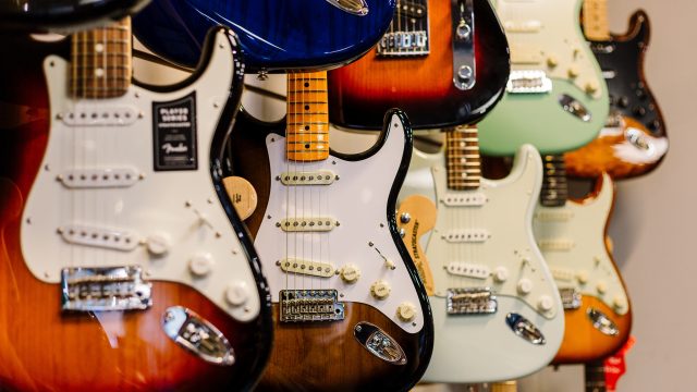 Nine electric guitars of various colours
