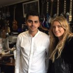 Christian and Ella Henderson in a room with guitars
