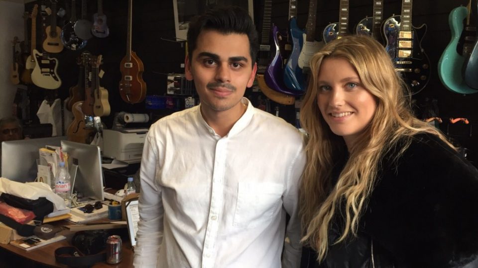 Christian and Ella Henderson in a room with guitars