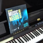 Piano, displaying a Take it away leaflet with the words: Because music needs backing